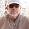 casual-dressed-middle-age-or-elderly-man-with-black-sunglasses-white-picture-id1223383820